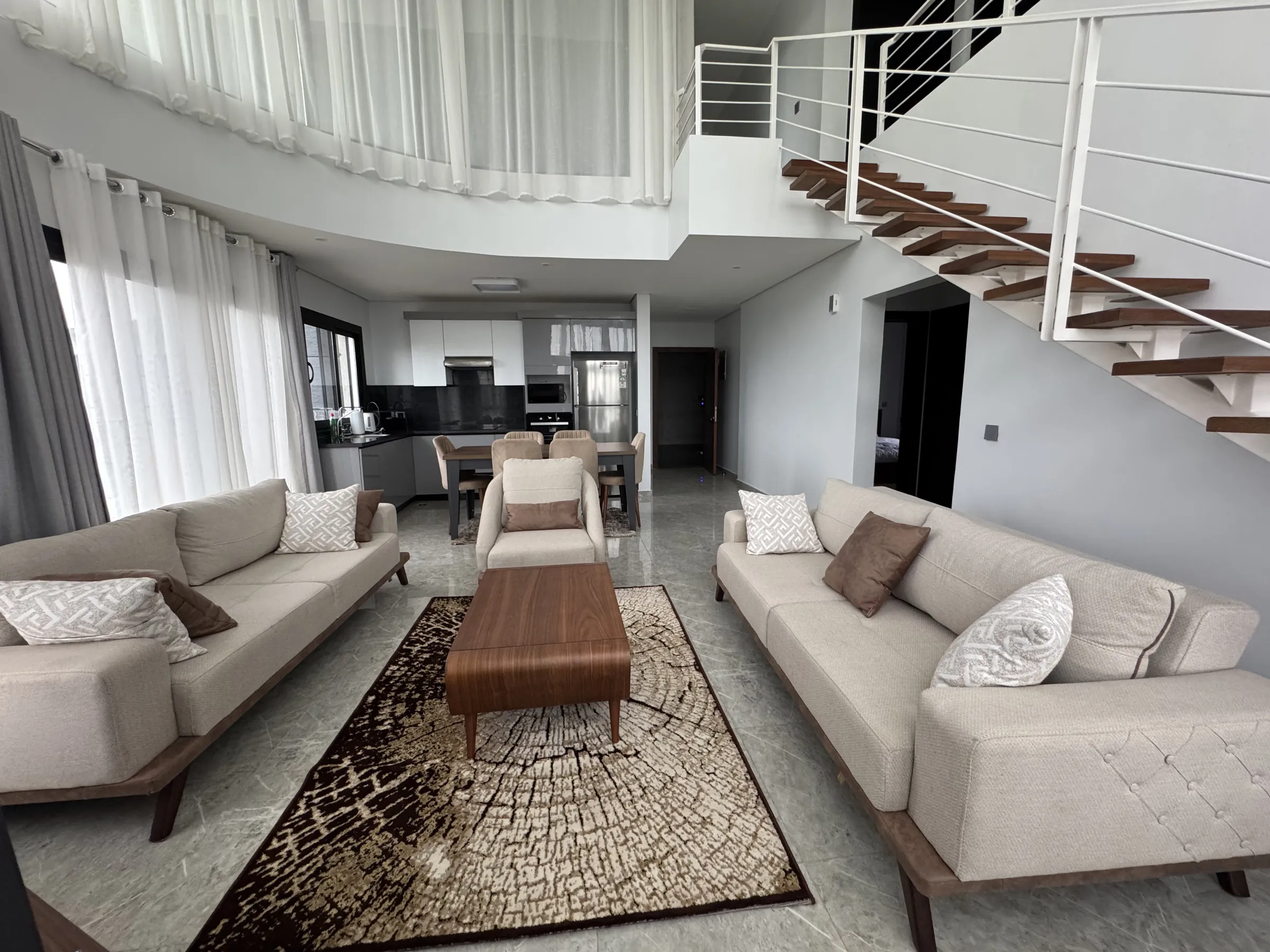 Double-height duplex living room with staircase